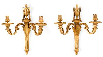 577. A pair of late 18th century Louis XVI gilt bronze two-light wall-lights.