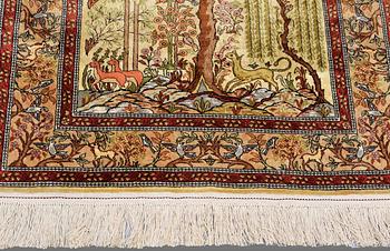 An Oriental figural silk rug, ca 117 x 78 cm.