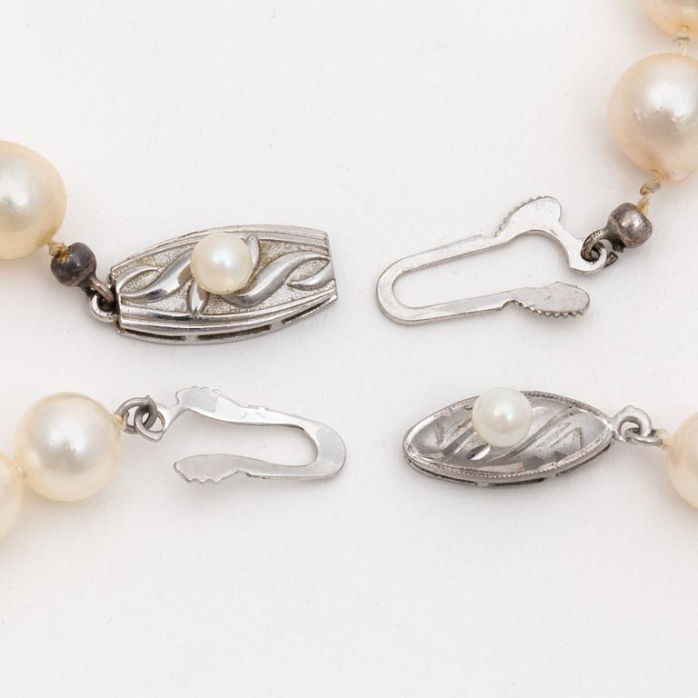 Two cultured pearl necklaces with silver clasps.