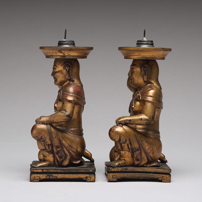 A pair of gilt lacquered candle holders, late Qing dynasty.