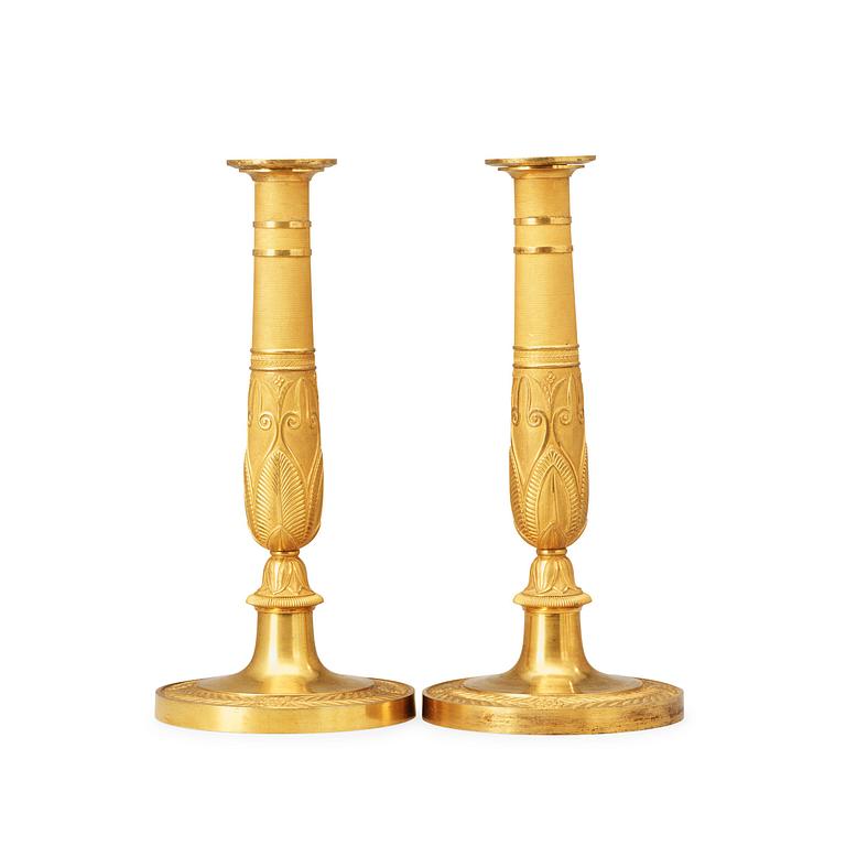 A pair of French Empire early 19th century gilt bronze candlesticks.