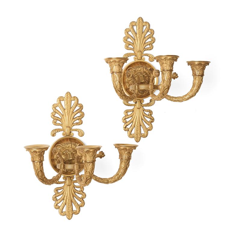 A pair of French Empire early 19th century three-light wall-lights.