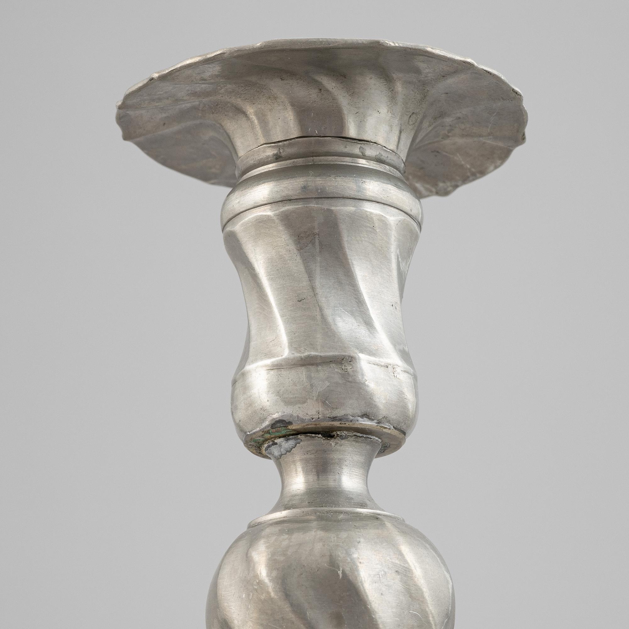A pair of rococo style pewter candlesticks, 19th Century.