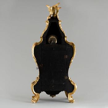 A 19th century mantle clock in the style of Louis XV.