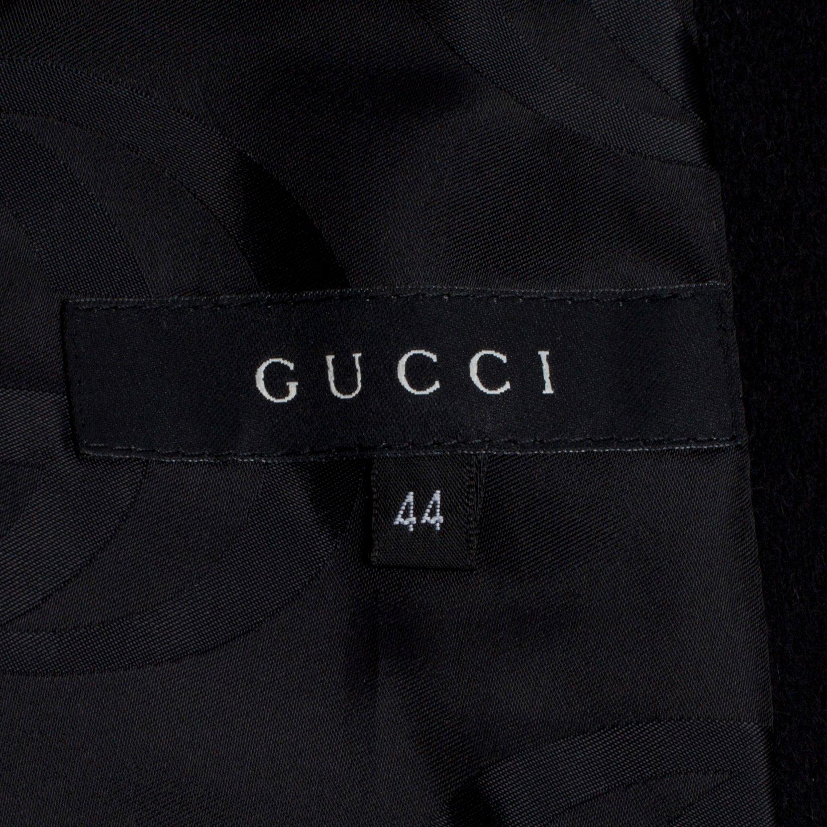 GUCCI, a black wool blend coat.