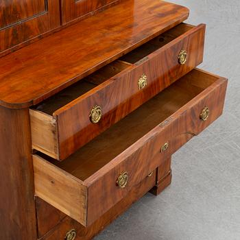 A mahogany veneered Empire cupboard, first half of the 19th century.