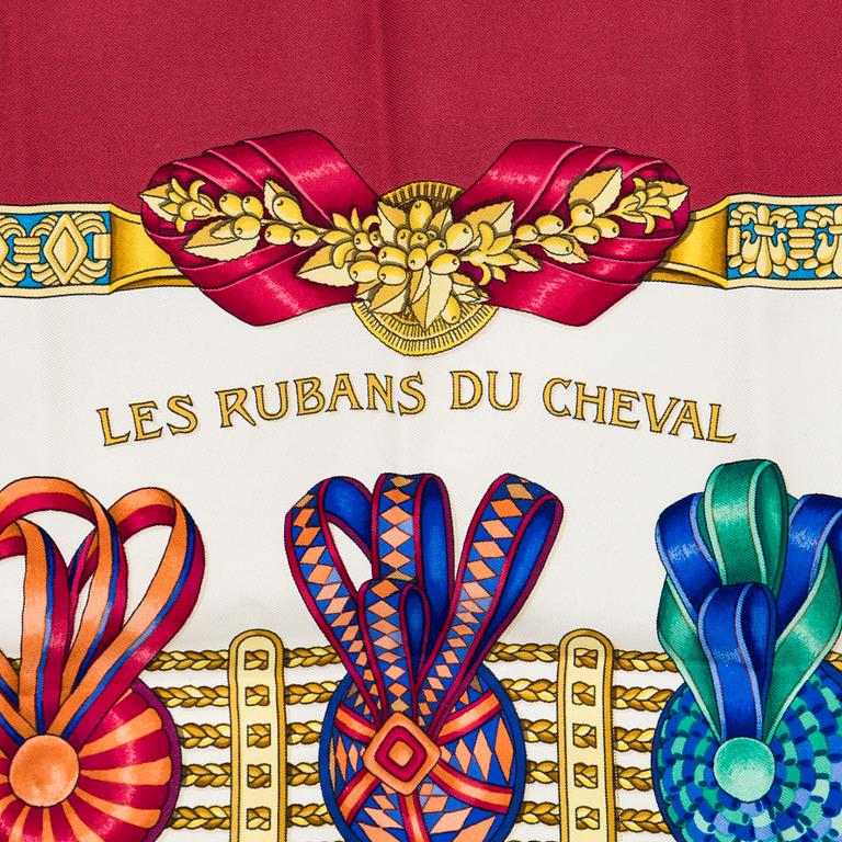 Hermès, a 'Les Rubans du Cheval' silk scarf.