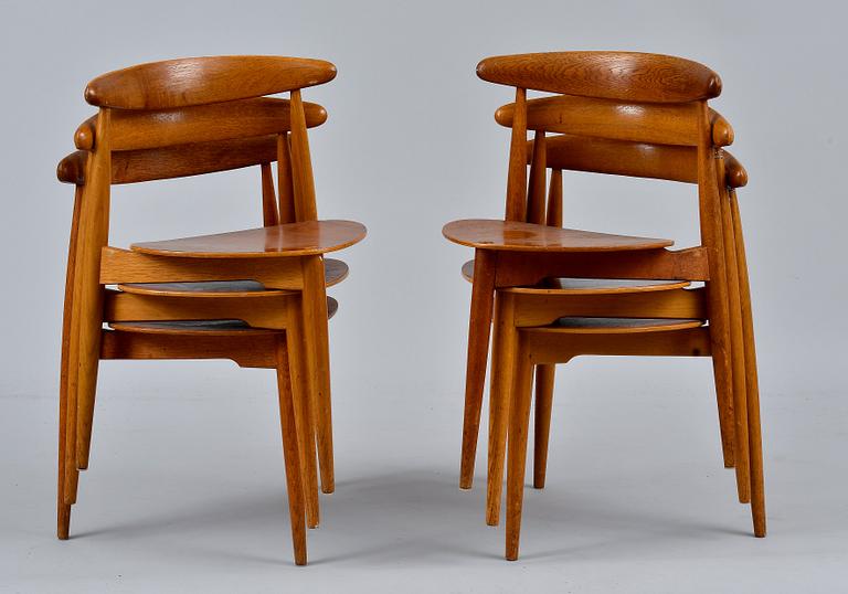Hans J. Wegner, A SET OF SIX CHAIRS AND A TABLE, The Heart Chair. Beech and oak, teak on seats.