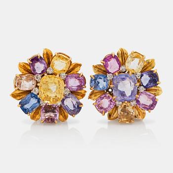 623. A pair of multi coloured sapphire and brilliant cut diamond clip brooches, one signed Cartier London.