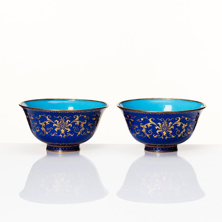 A pair of gilt decorated blue ground painted enamel bowls, Qianlong four character seal mark and period (1736-95).