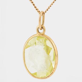 Pendant with yellow-green stone featuring the intaglio of the zodiac sign of Pisces, with a gold chain.