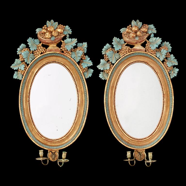 A pair of Swedish Empire two-light mirror girandoles.