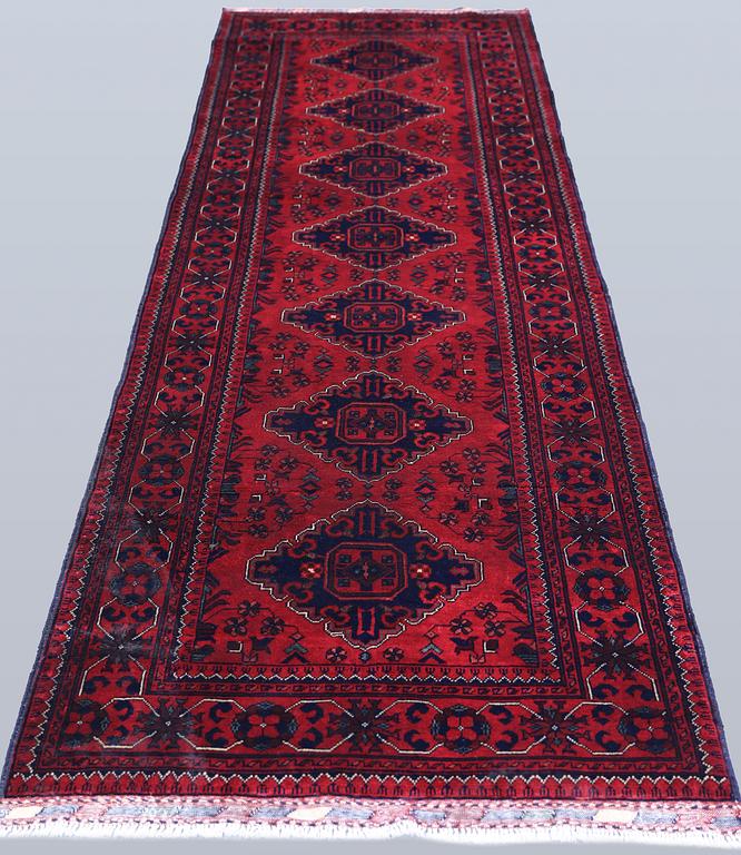 An Afghan runner, approximately 283 x 87 cm.