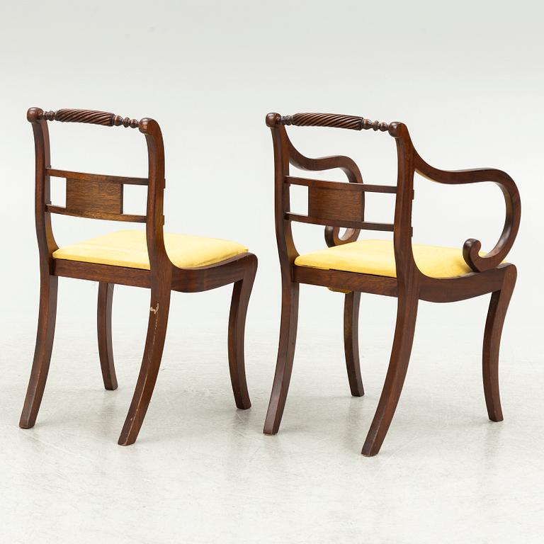 An Empire style dining table and ten chairs, second half of the 20th Century.