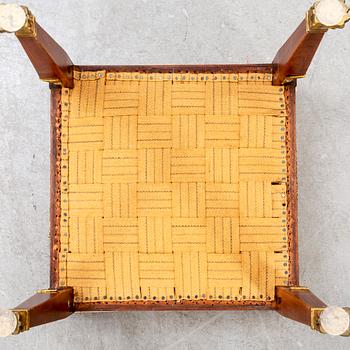 An Empire style mahogany stool around 1900.