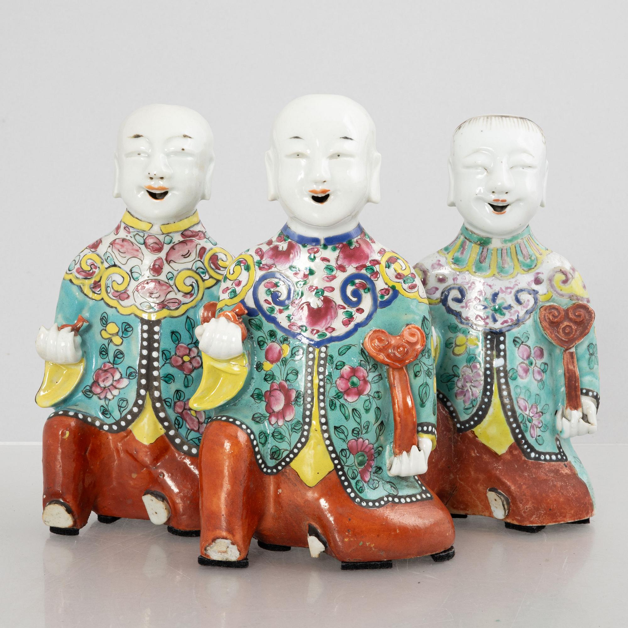 A group of three Chinese porcelain 'Laughing boys' figures, Qing dynasty and later.