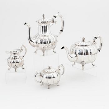 A rococo style sterling silver teapot, coffee pot, creamer and sugar bowl.