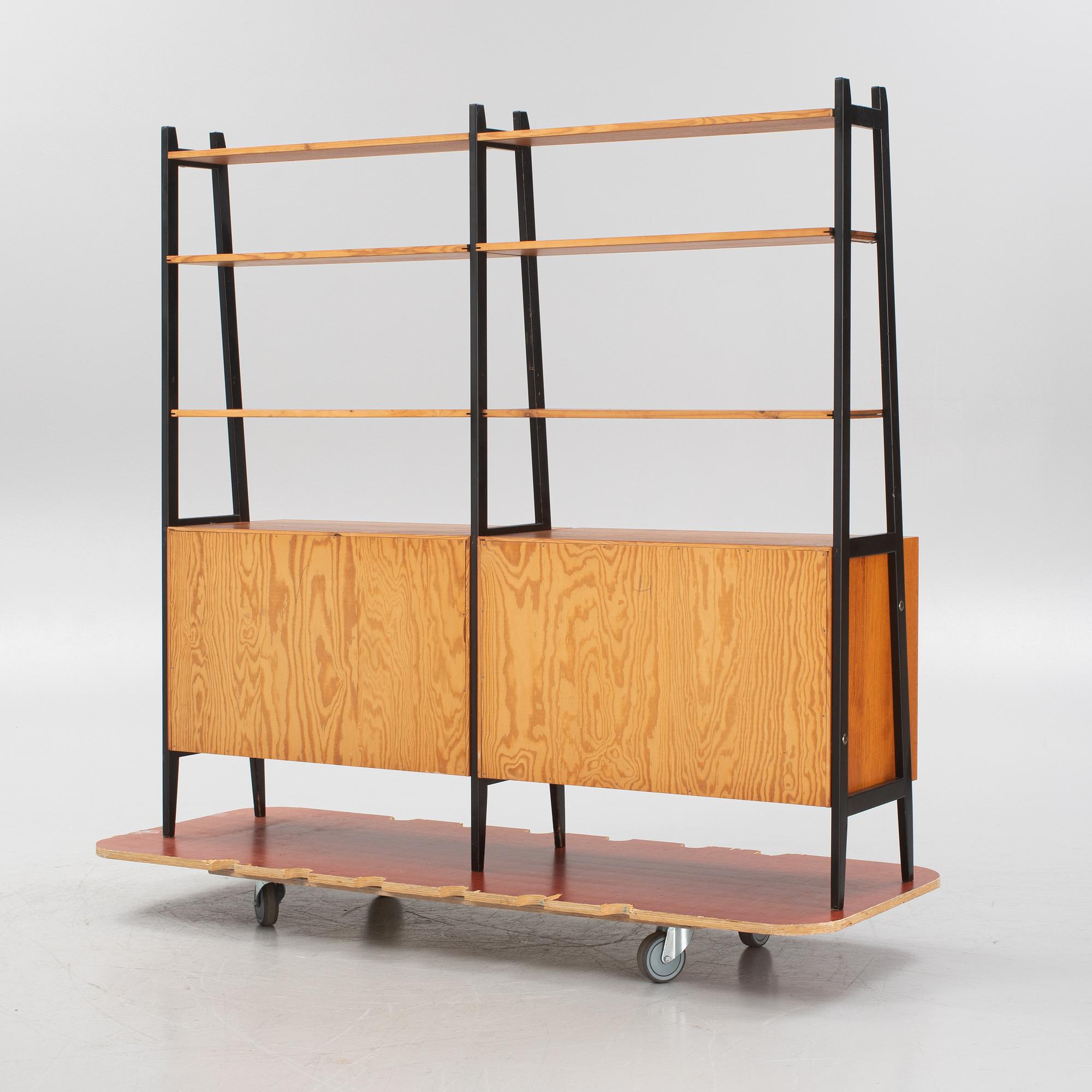 Teak veneered book cases with cabinets.