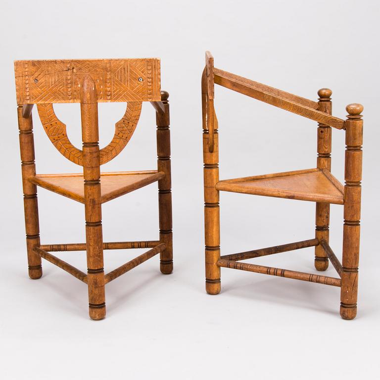 A pair of early 20th Century carved oak armchairs.