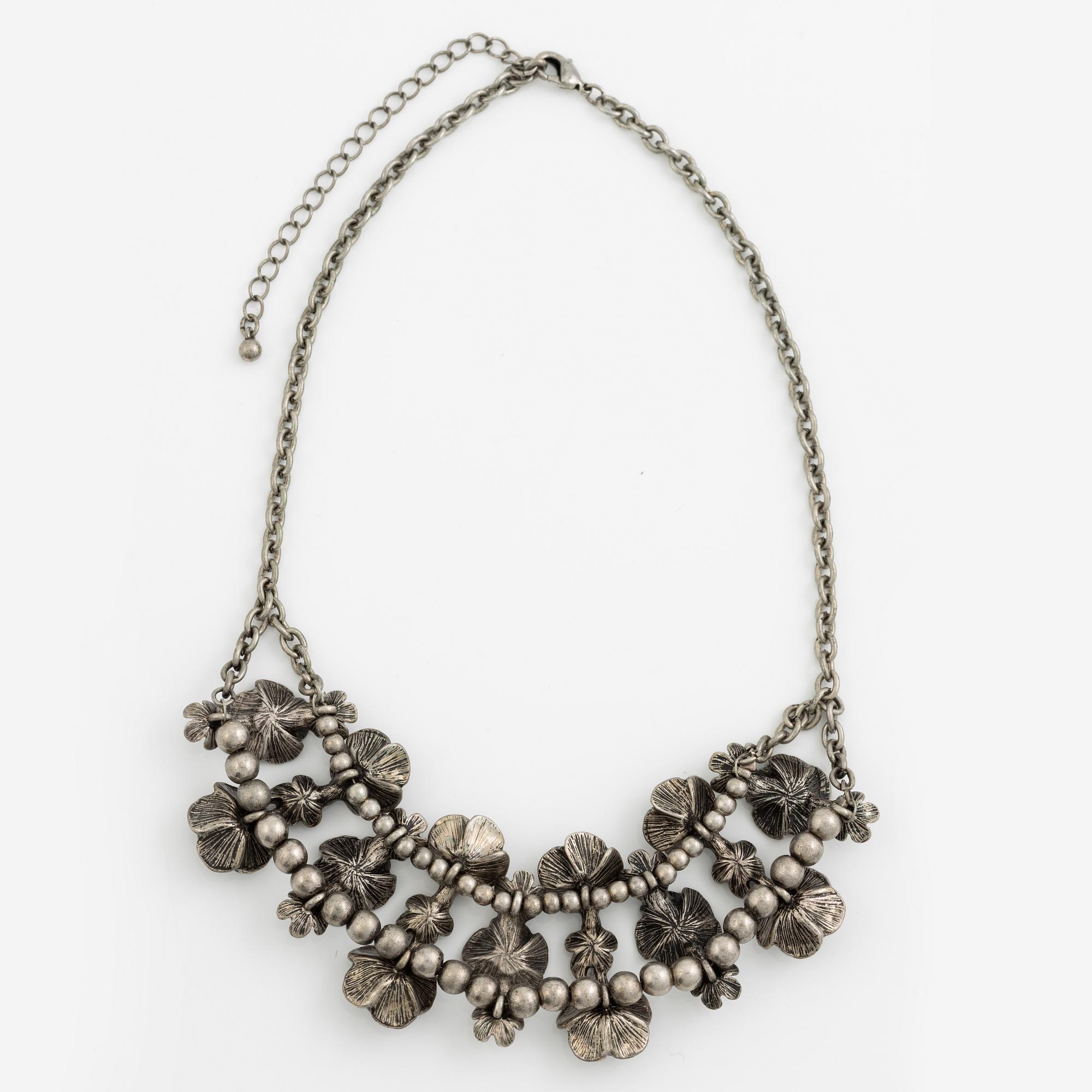 Necklace with matching earrings, white metal in floral design with glass stones.