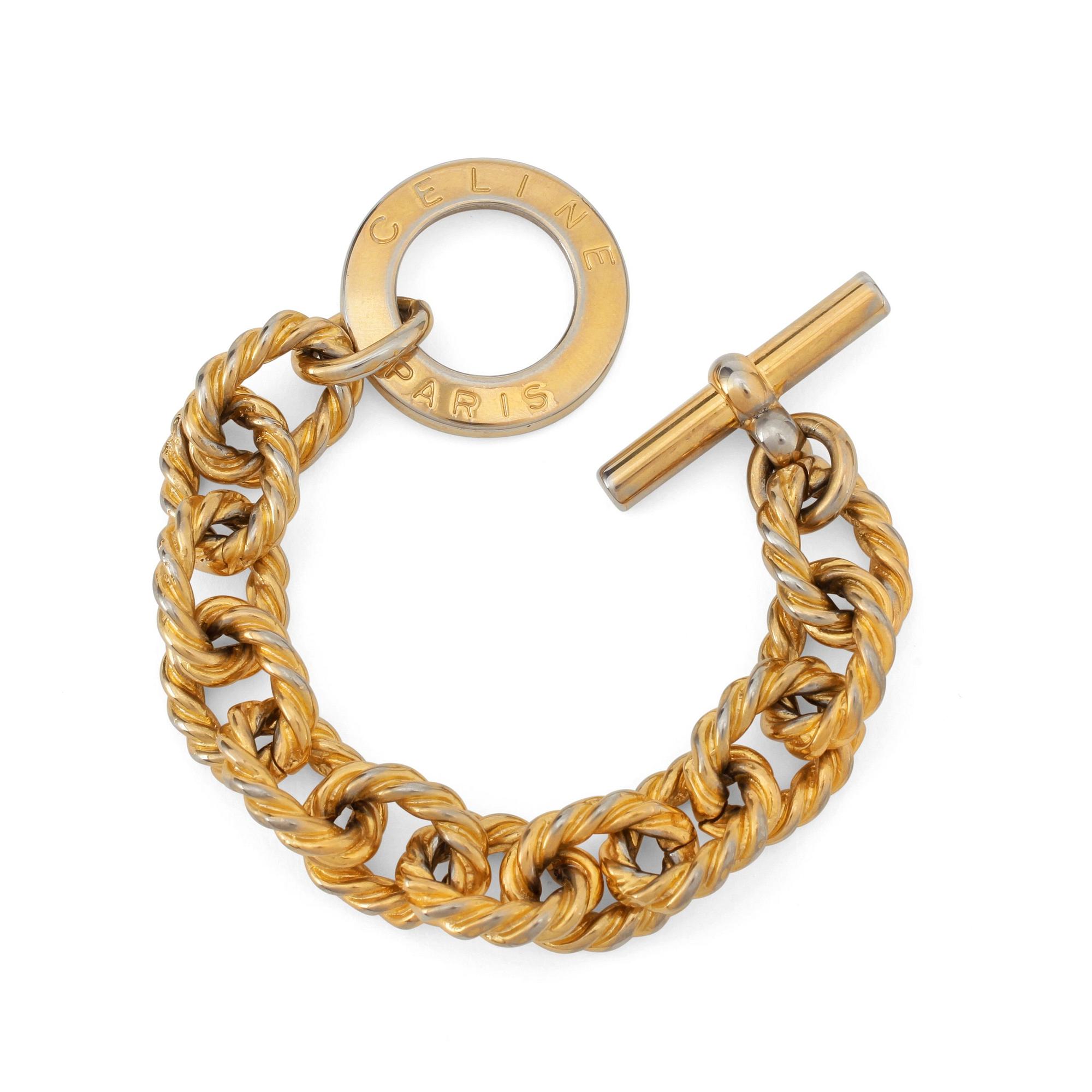 CÈLINE, a gold coloured bracelet.