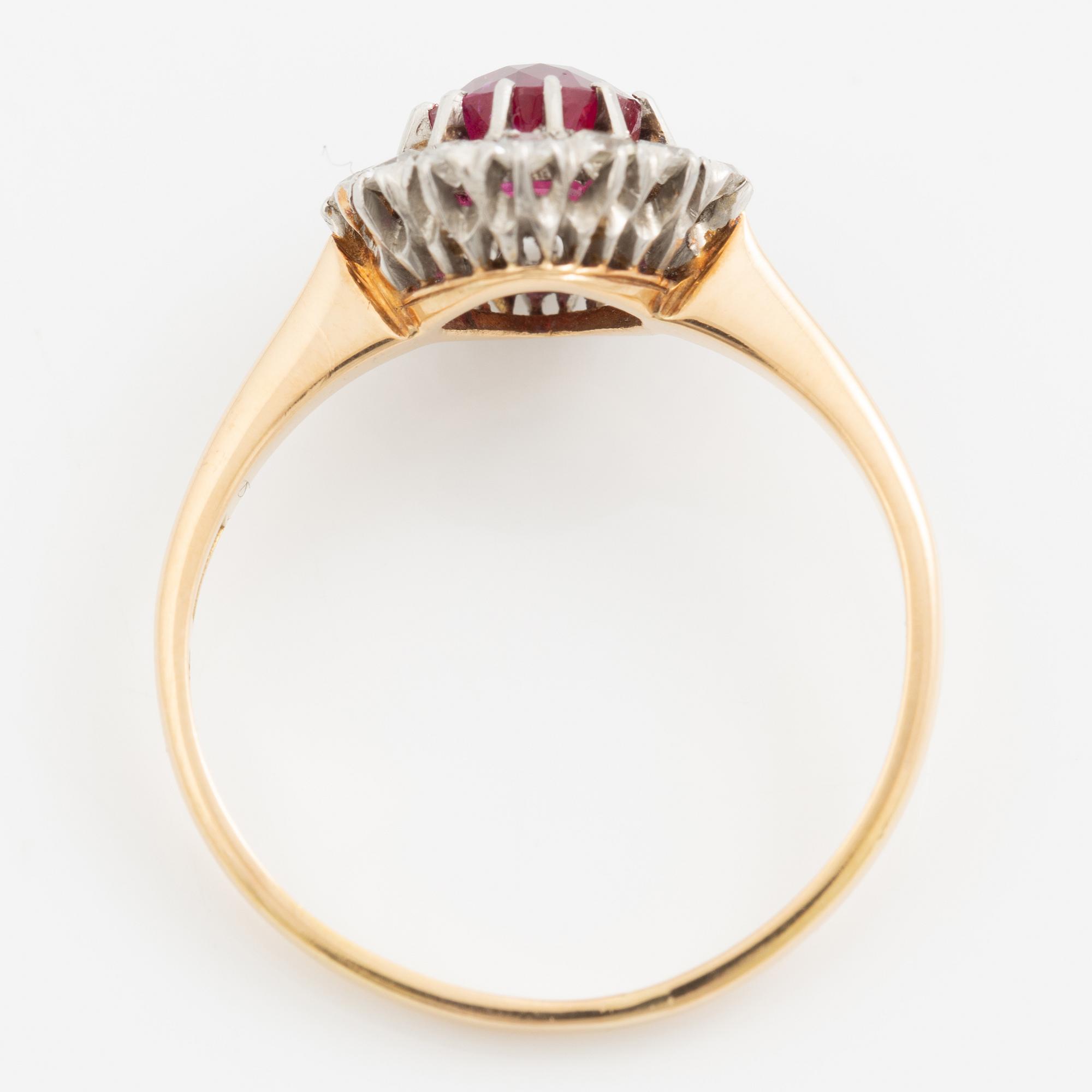 Ring in 18K gold set with a faceted synthetic ruby and eight-cut diamonds.