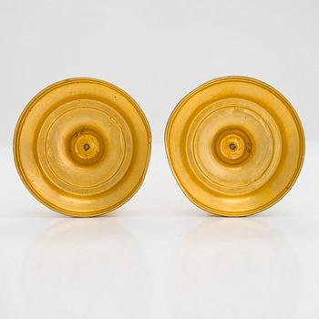 A pair of mid-19th-century gilded bronze candlesticks.