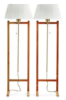 359. A pair of Josef Frank walnut and brass floor lamp by Svenskt Tenn, model 2548.