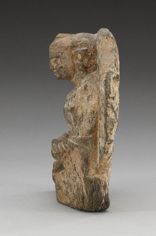 A carved stone figure of a sitting Buddha, presumably Ghandara.