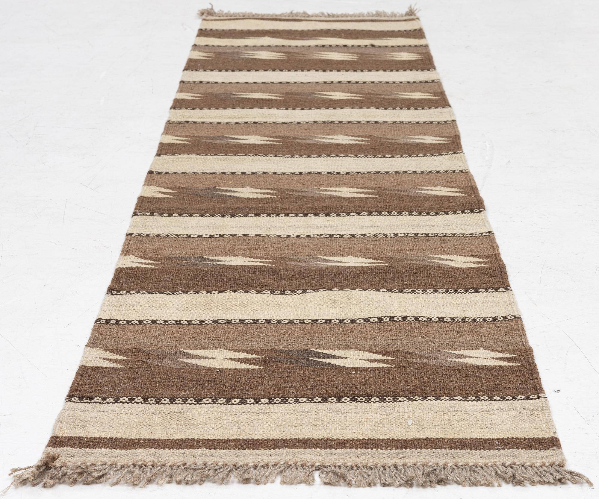 A Persian kilim runner, c. 248 x 62 cm.