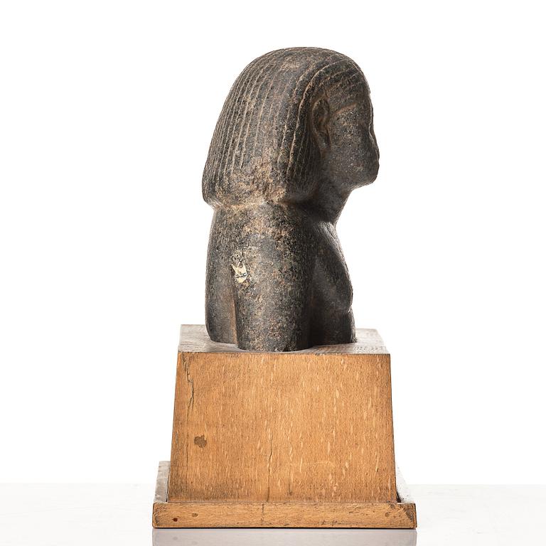 An Egyptian granite bust of an official, Middle Kingdom ca 1900 B.C.