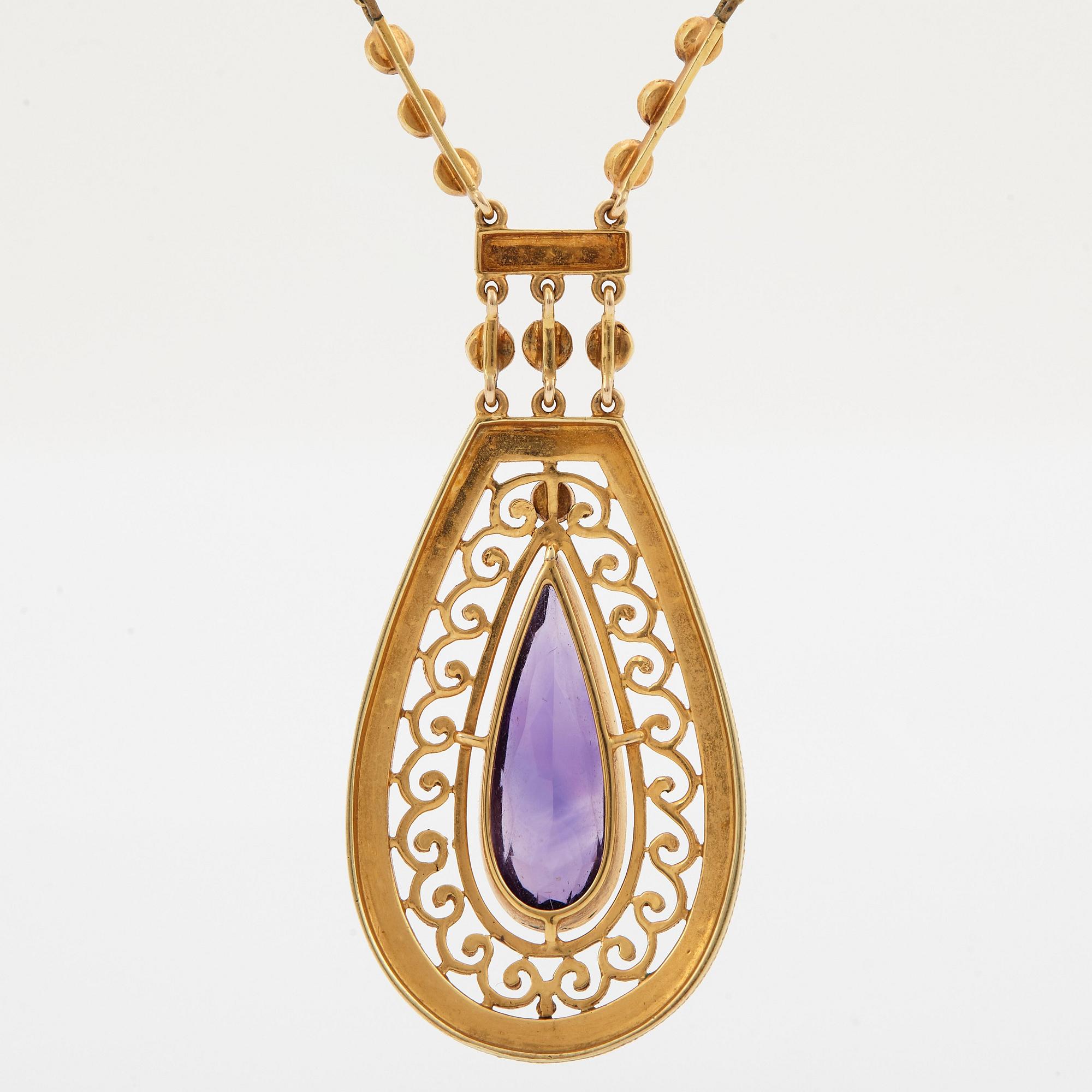 A 14K gold necklace set with a faceted amethyst and pearls.