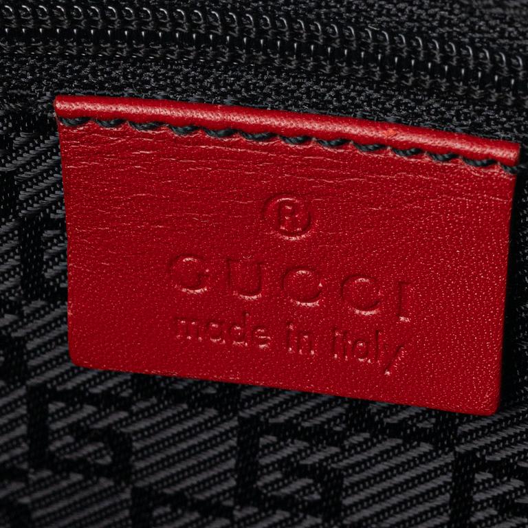 Gucci, a red leather handbag.