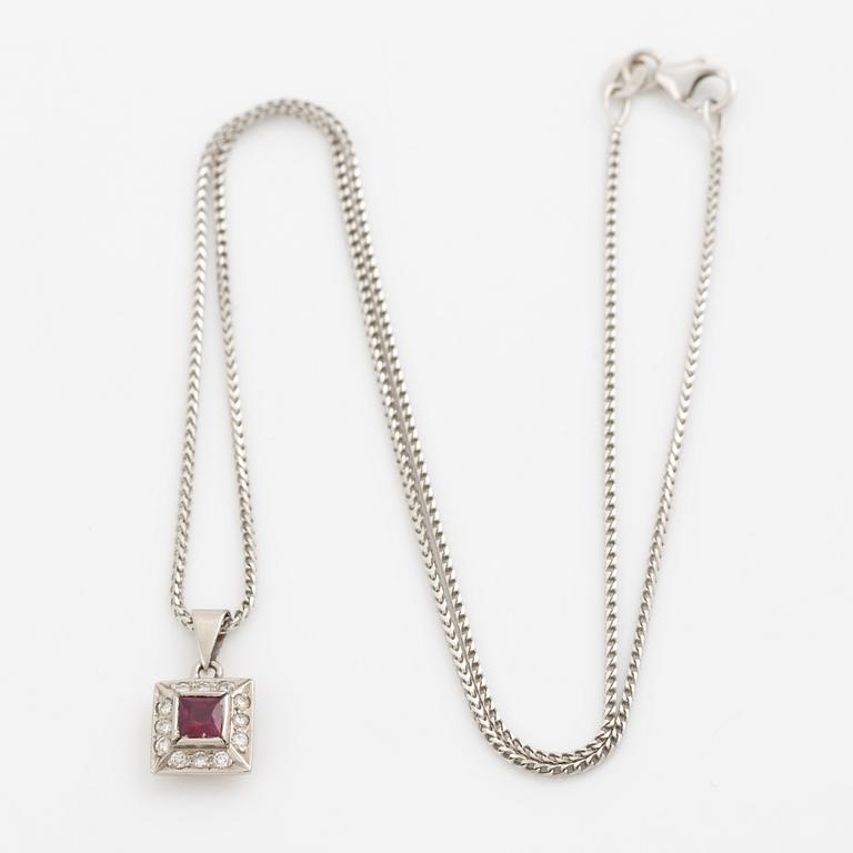 Pendant with chain in 18K white gold featuring a red stone, likely a ruby, and diamonds.