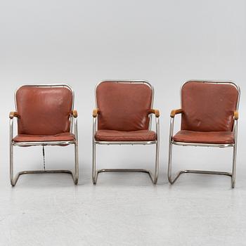 Three tubular steel armchairs, mid 20th Century.