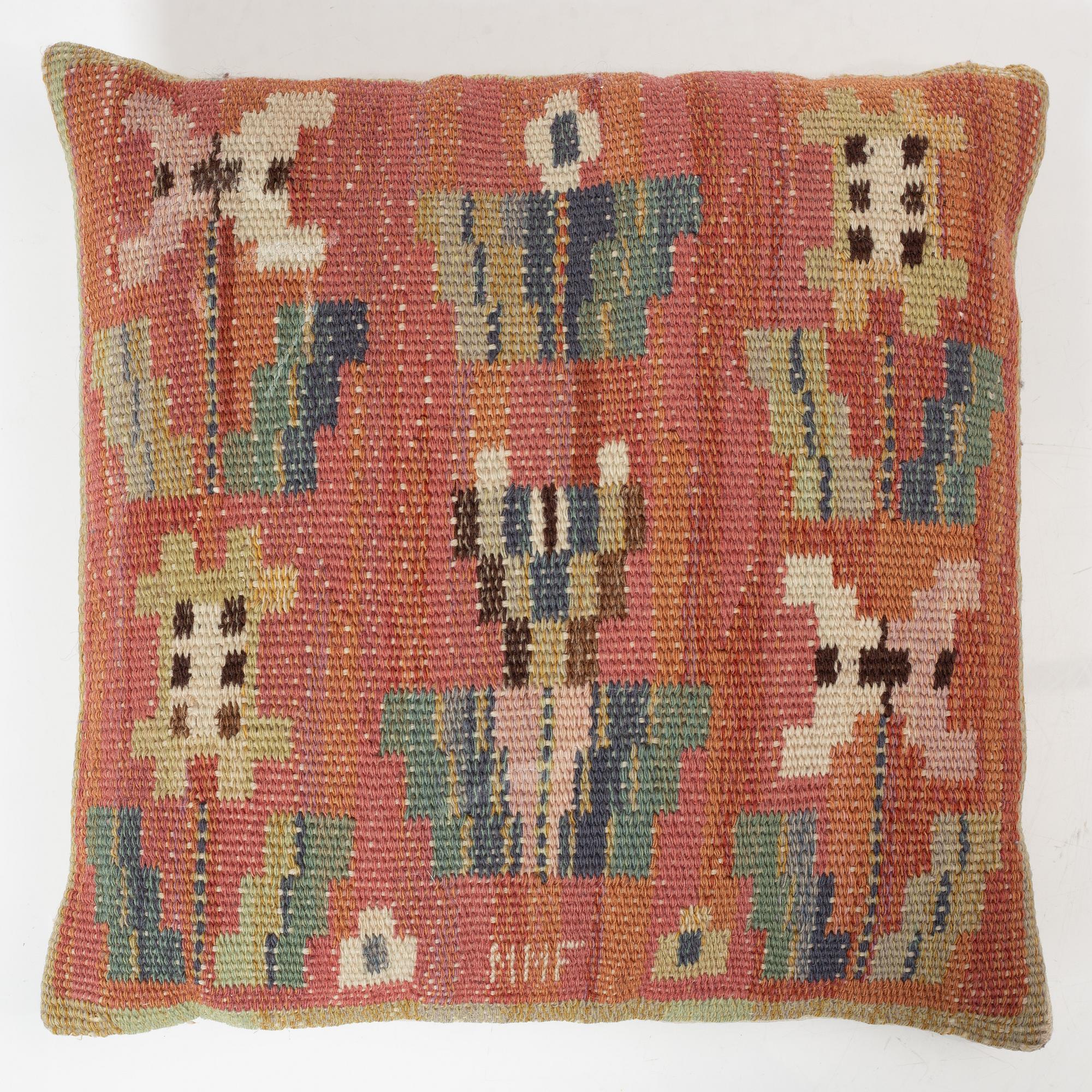 Märta Måås-Fjetterström, a cushion, 'Blommor på röd botten', signed MMF, c. 32 x 32 cm.