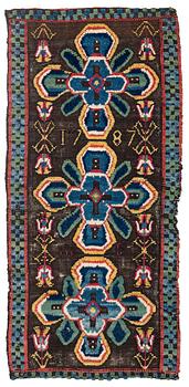 316. A carrige cushion, knotted pile in relief, ca 100 x 46 cm probably Skytts district dated 1787.