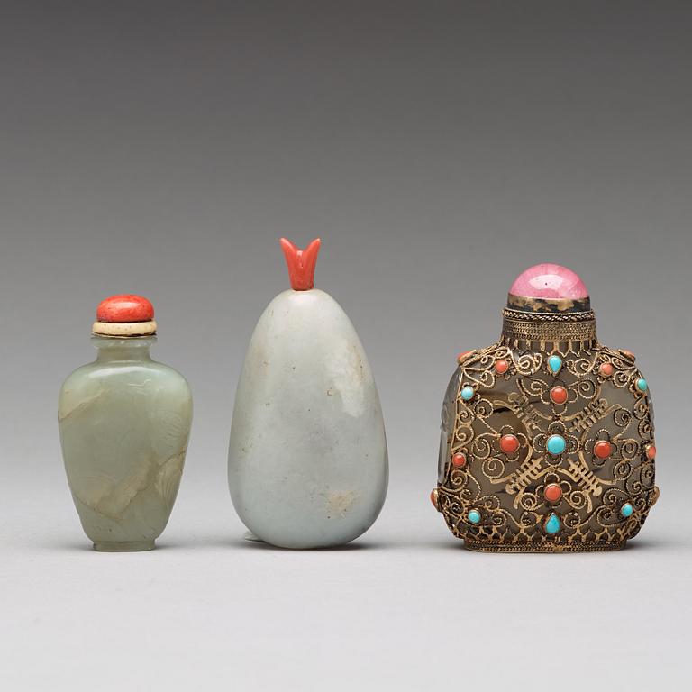 Three nephrite and agathe snuff bottles with stoppers, China and Tibet, late 19th Century.