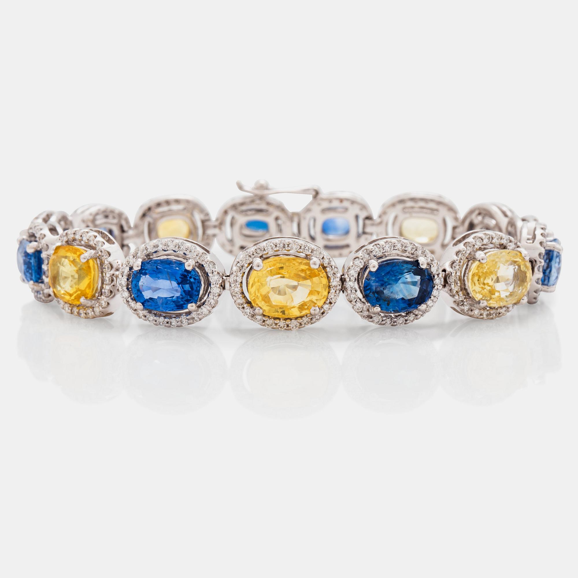 A yellow and blue sapphire and brilliant cut diamond bracelet. Total carat weight of sapphires circa 28.00 cts.