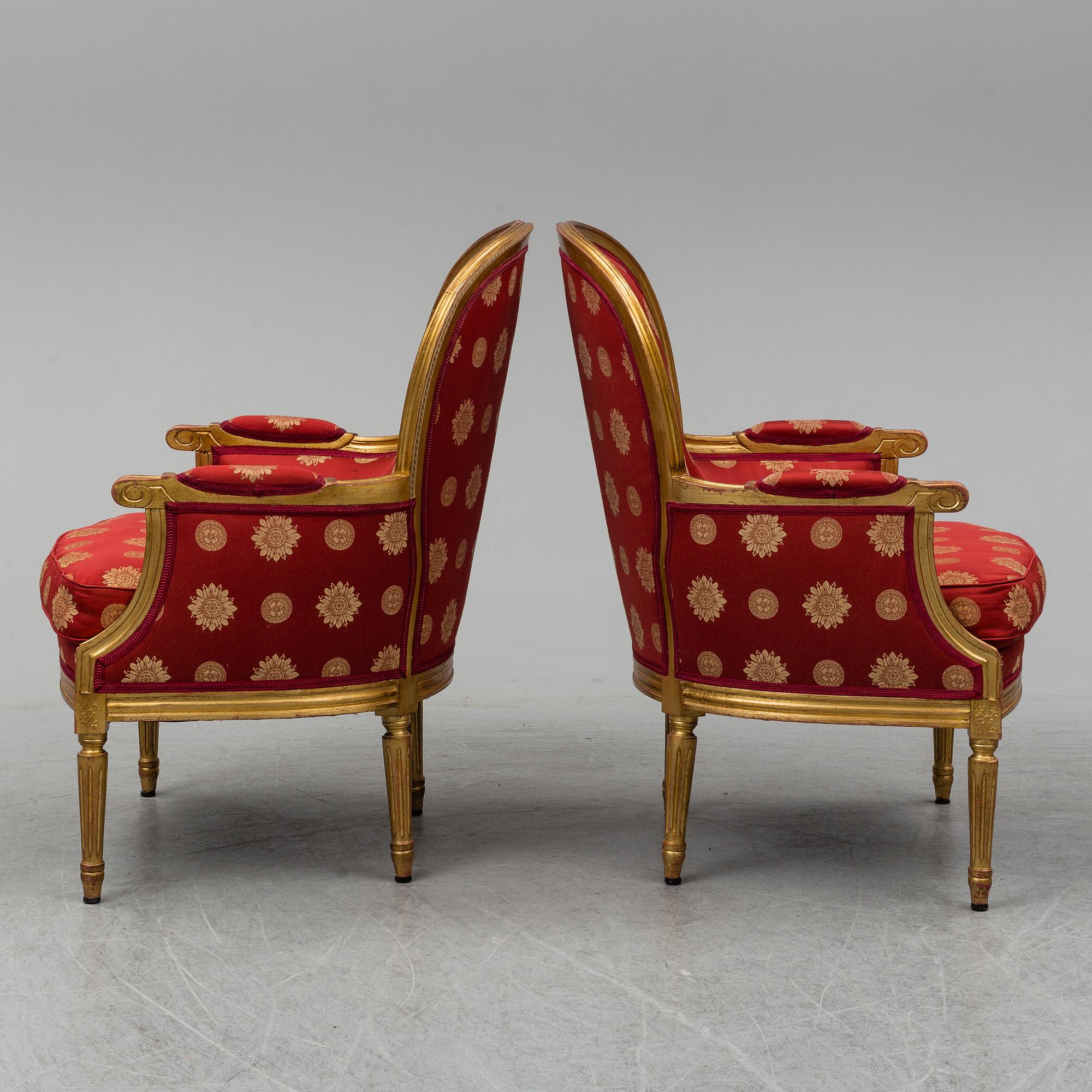 A pair of Louis XVI-style armchairs.