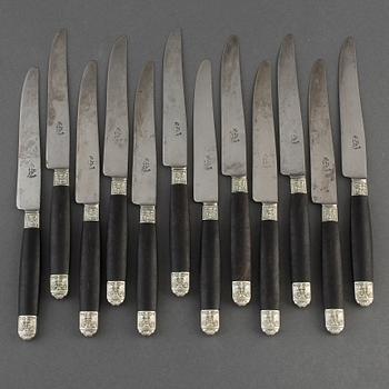 A set of twelve French 19th century ebony with silver dinner-knifes, unmarked.