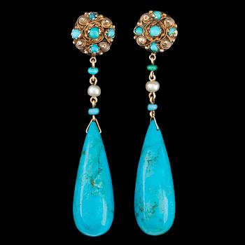 1067. A pair of drop shaped turqouise earrings.