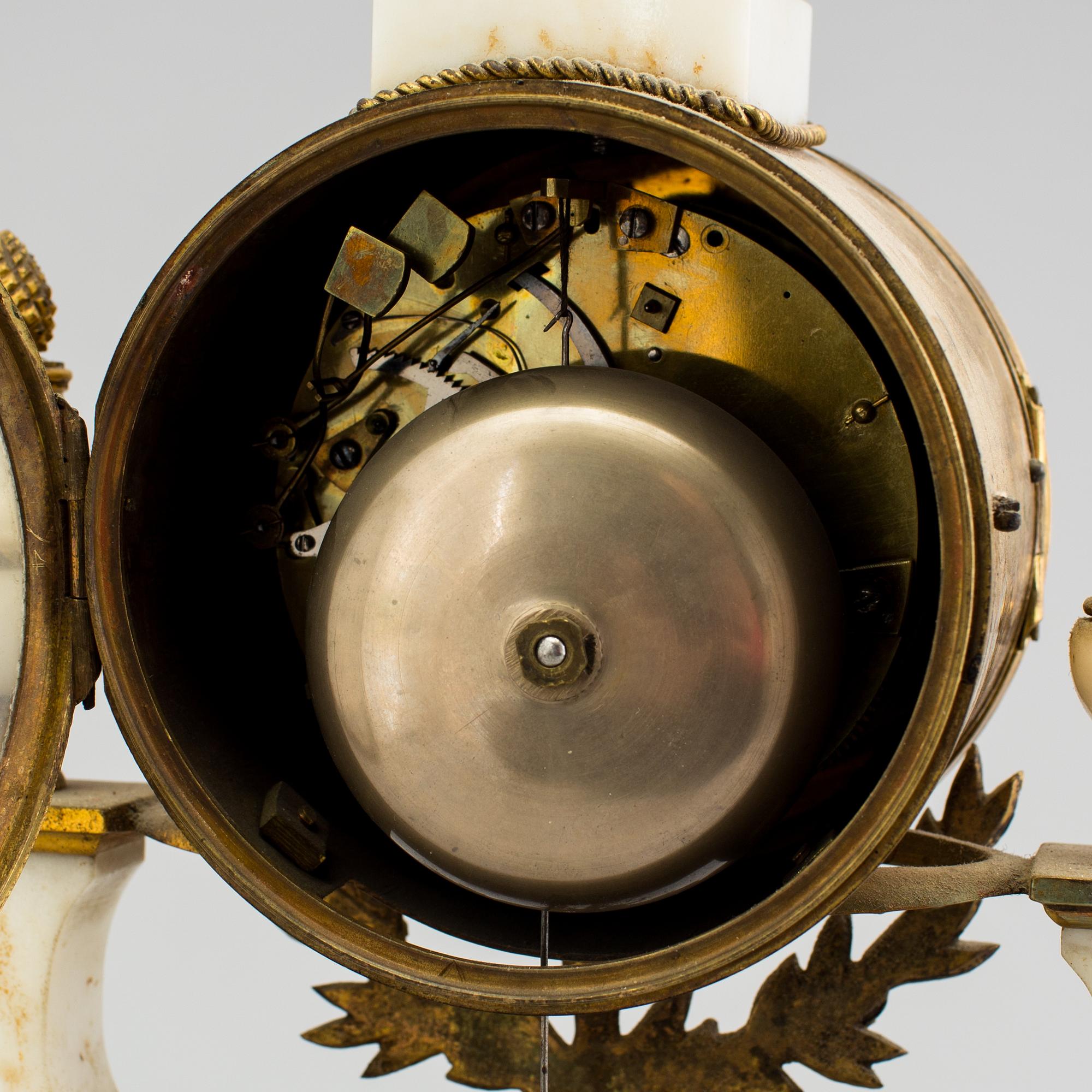 A Louis XVI marble and bronze mantel clock from the second half of the 18th century.