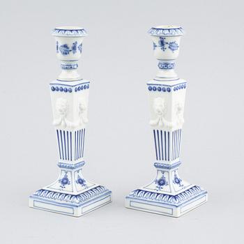 A pair of "Musselmalet" candlesticks in porcelain, by Royal Copenhagen, second half of the 20th century.