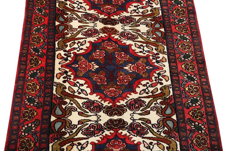 An oriental runner carpet, c. 295 x 95 cm.