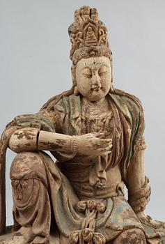 A seated wooden figure of Guanyin, presumably Ming dynasty (1368-1644).
