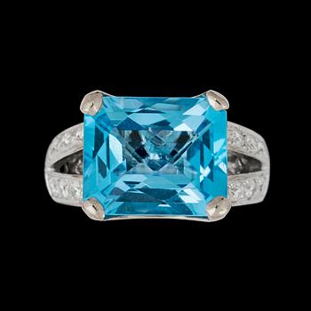 A topaz, circa 16 cts, and diamond, total gem weight circa 0.60 ct, ring.