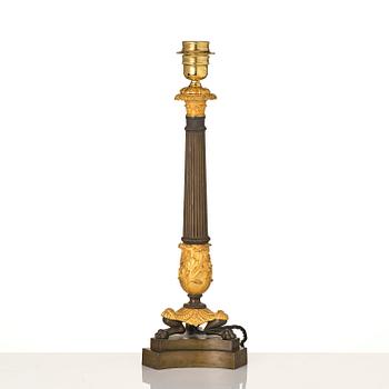 A French Empire ormolu and patinated bronze table lamp, early 19th century.