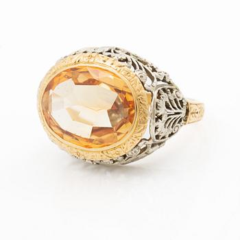 Gold ring with synthetic yellow sapphire.