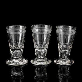 A glass bottle and three vodka glasses, 19th Century.